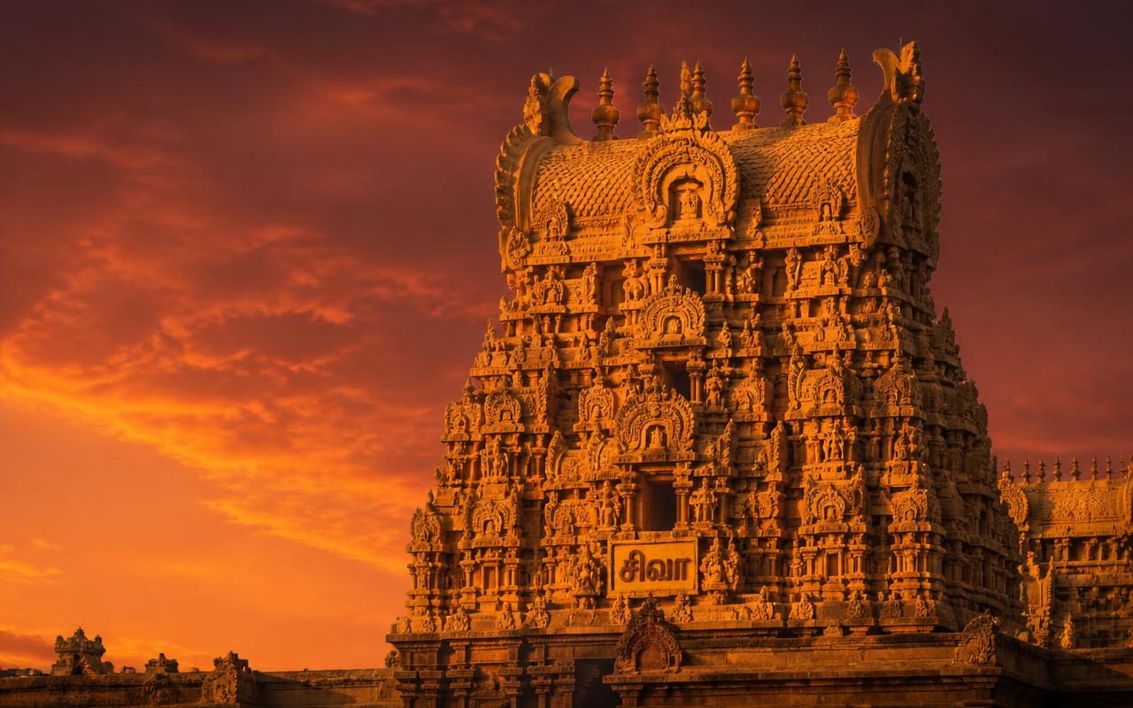 Golden gopuram of a South Indian temple at sunset